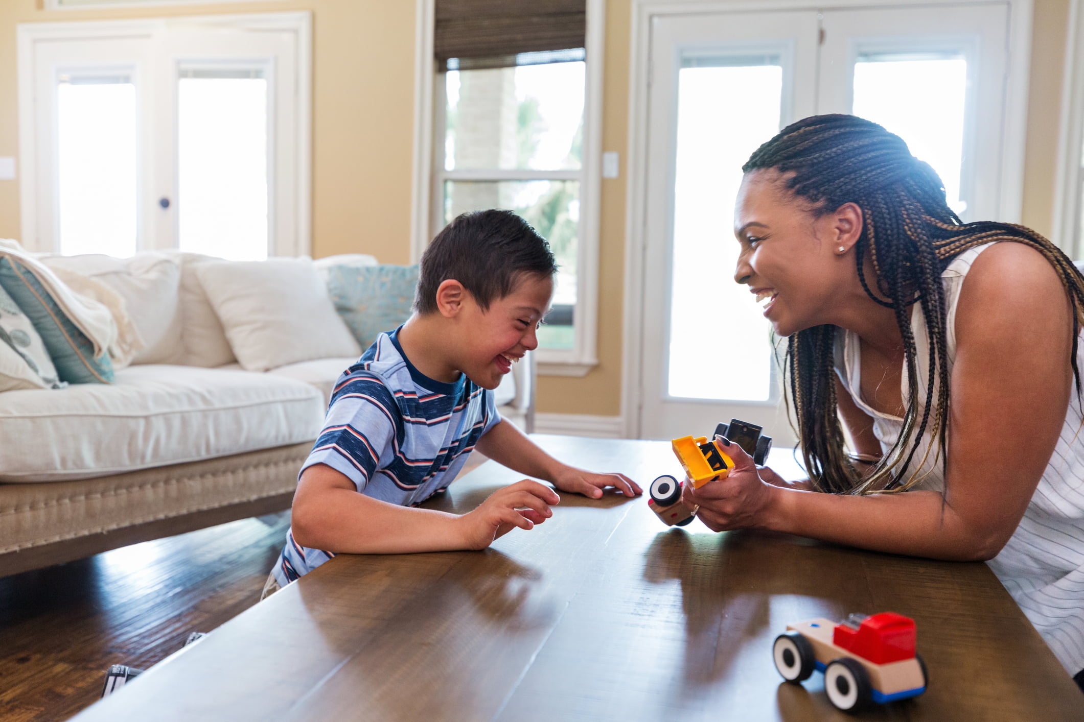 Adult therapist uses play therapy with young boy