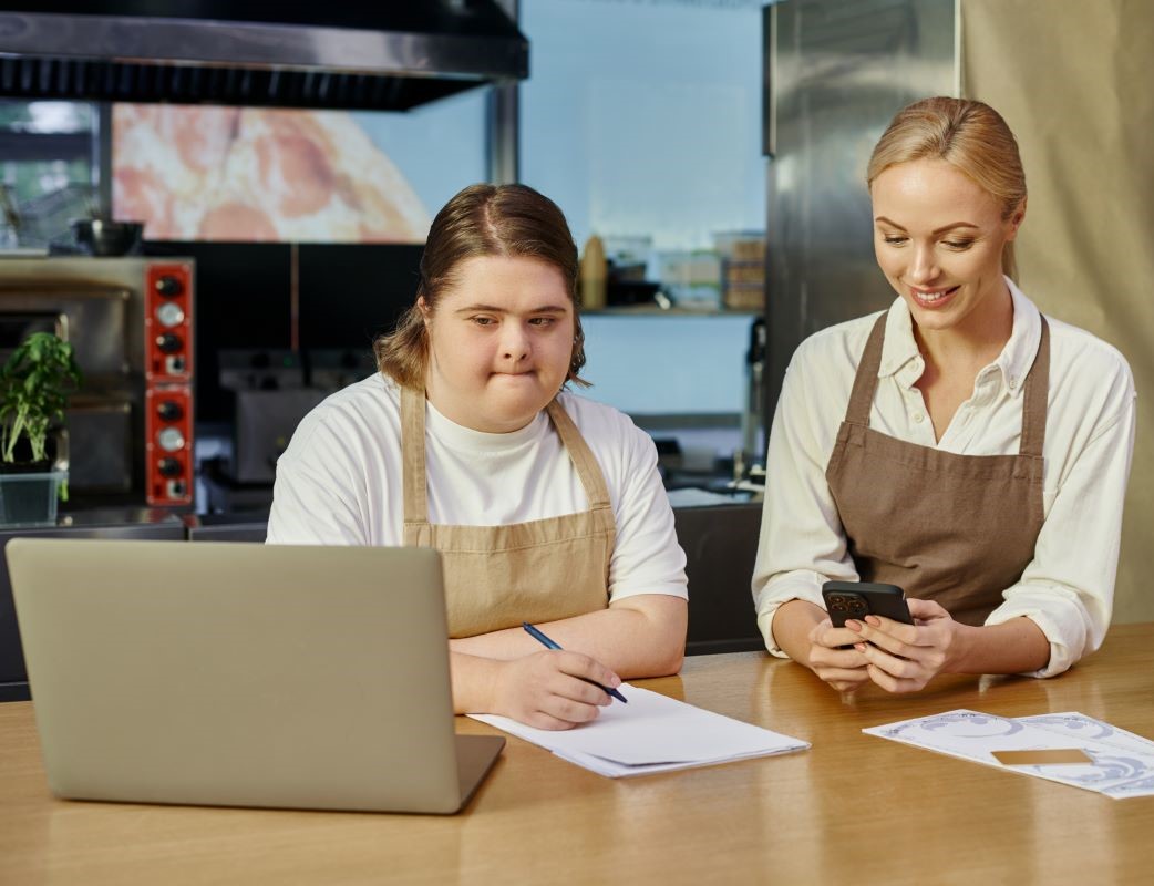 A young woman with Down syndrome works at a cafe.