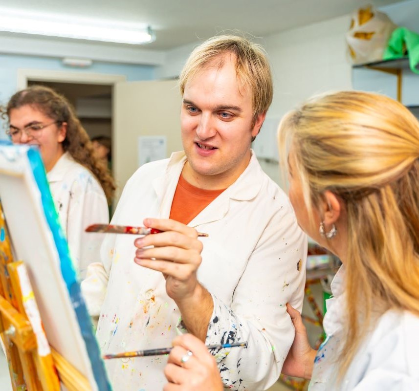 A mentally disabled man enjoys an art class.